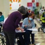 Before receiving the vaccine, each patient goes through paperwork with staff. (Photo: Olivia Smucker)