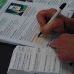Vaccination cards being filled out, specifying recipients' information and next appointment. (Photo: Olivia Smucker)