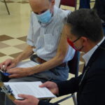 John Lines, director of LG Health's public relations and corporate communications, checks in with a patient after his vaccine. (Photo: Olivia Smucker)