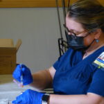Amanda Larrison works on filling up syringes with the Moderna doses. (Photo: Olivia Smucker)