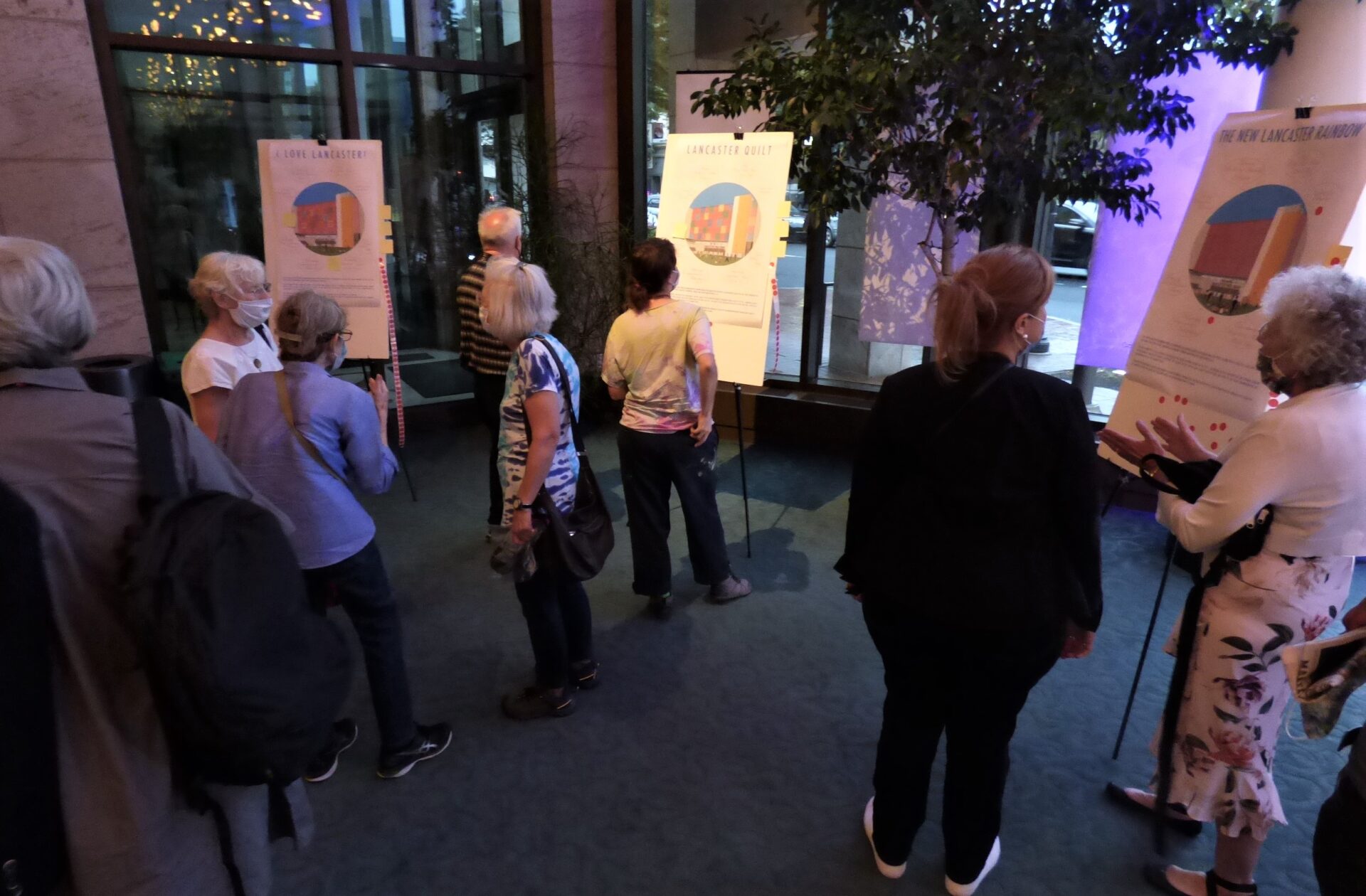 Audience members review R&R Studios' proposed designs for the Ewell Plaza public art in the lobby of the Ware Center following a presentation by Roberto Behar and Rosario Marquardt on Friday, Aug. 27, 2021. (Photo: Tim Stuhldreher) 