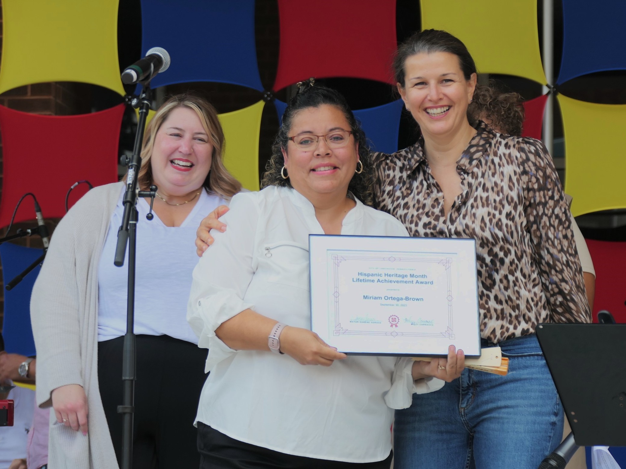 Flanked by City Council President Amanda Bakay, left, and Mayor Danene Sorace, right, Miriam Ortega-Brown shows off her Hispanic Heritage Lifetime Achievement Award during the Hispanic Heritage celebration on Saturday, Sept. 30, 2023. (Photo: Tim Stuhldreher) 